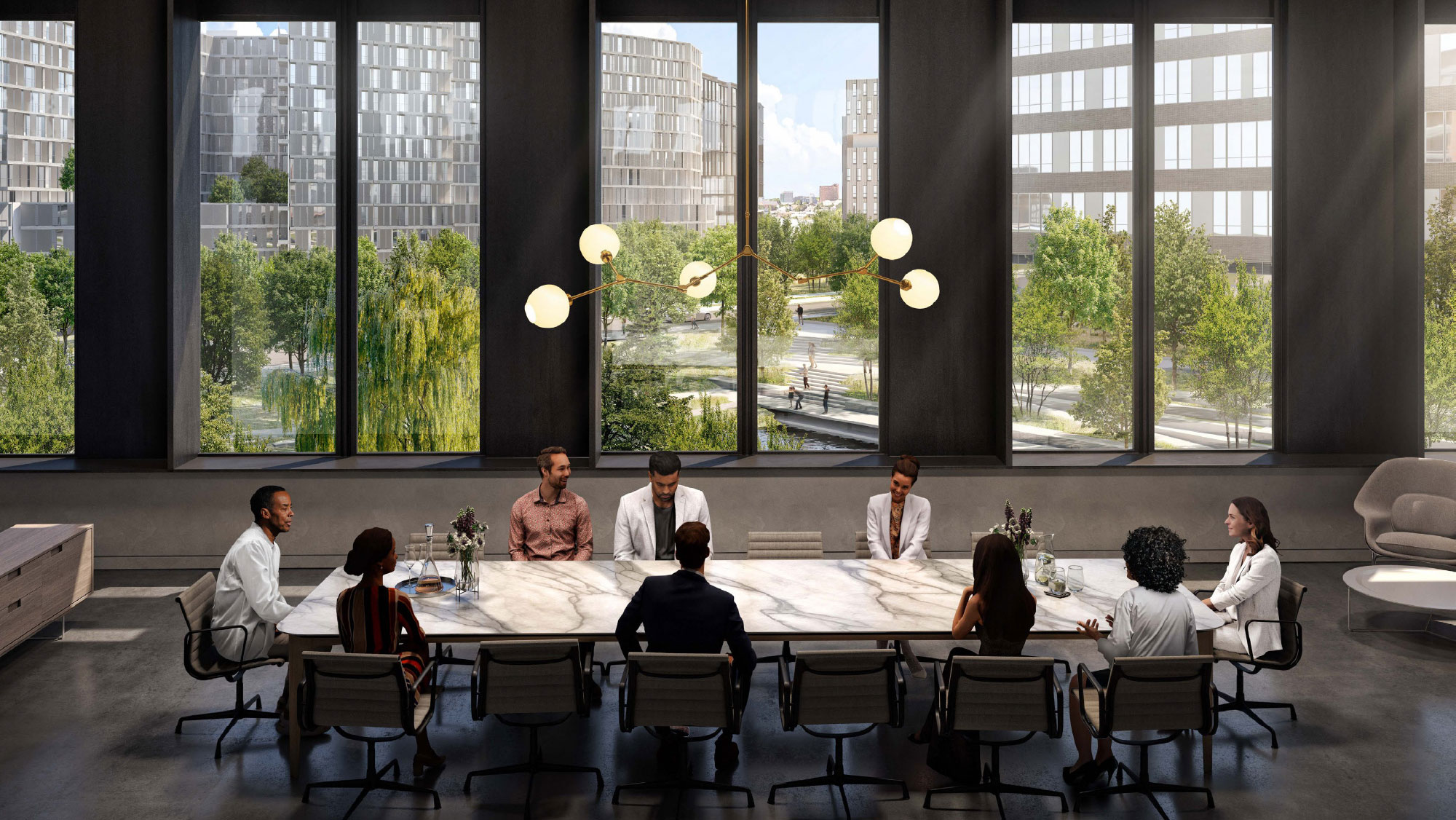 Colleagues sit around a 14-person table in a conference room