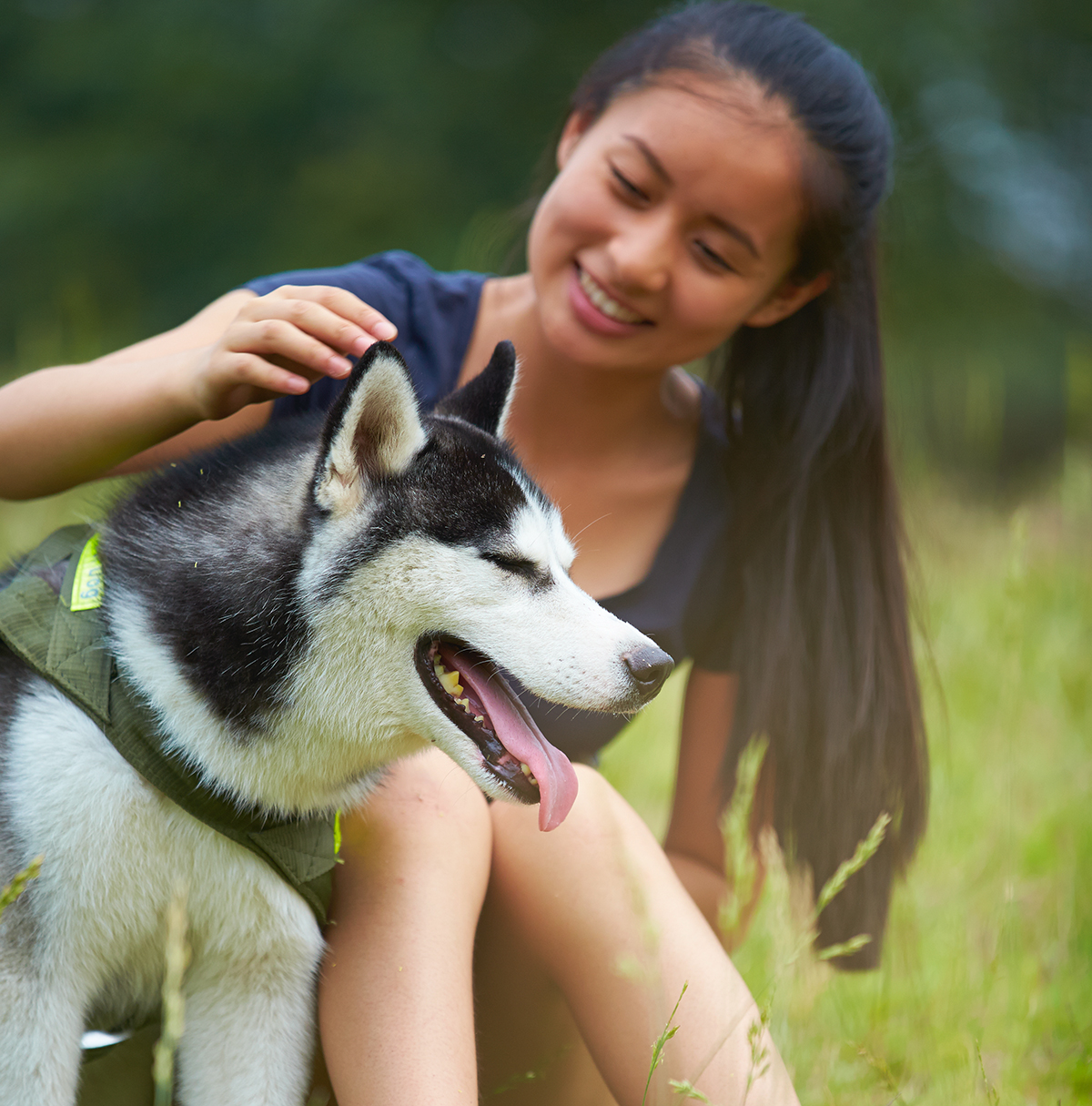 Woman petting dog outside in Suffolk Downs